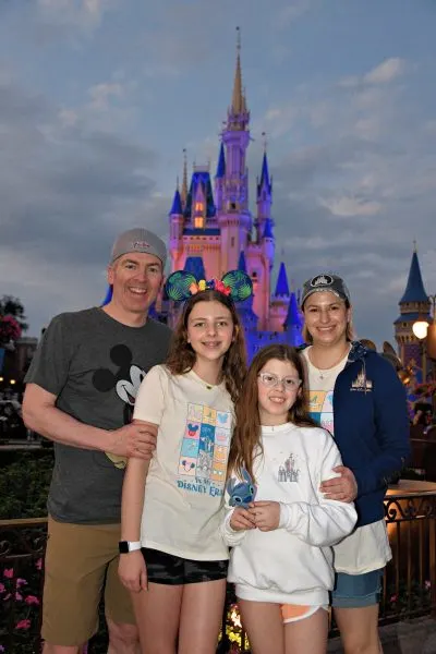 Annabel and her family in front of the castle at night
