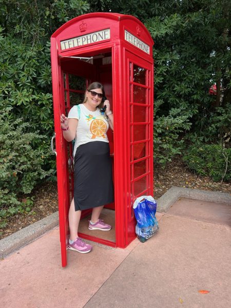 Ellen on the phone in England in Epcot
