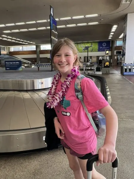 Stephanie's daughter with her lei at the airport