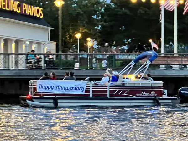 Happy Anniversary banner on pontoon boat for fireworks cruise