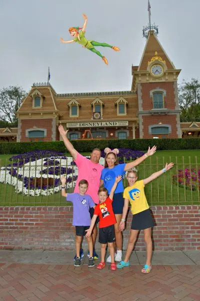 Kiley's family at Disneyland entrance with Peter Pan