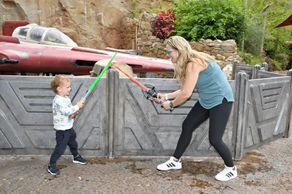 Liz light saber fighting with her son