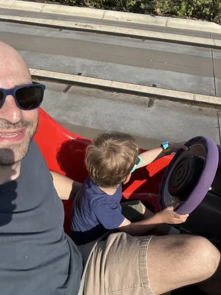 Liz's husband and son on Tomorrowland Speedway