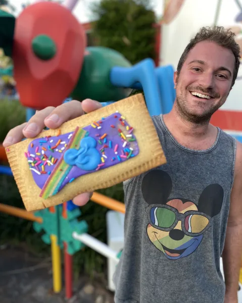 Shay with a pride pastry