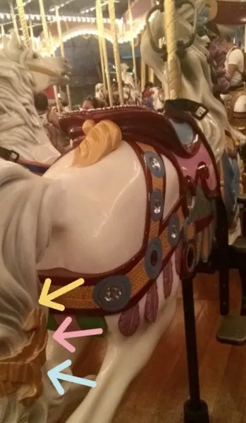 cinderella's horse with gold ribbon on prince charming regal carrousel