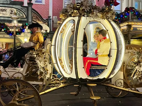 cinderella and prince charming during mickey's once upon a christmastime parade