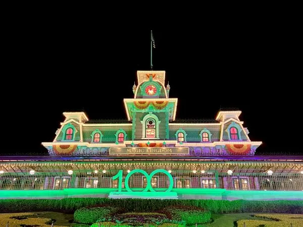 magic kingdom entrance at mickey's not so scary halloween party with 100 platinum sign
