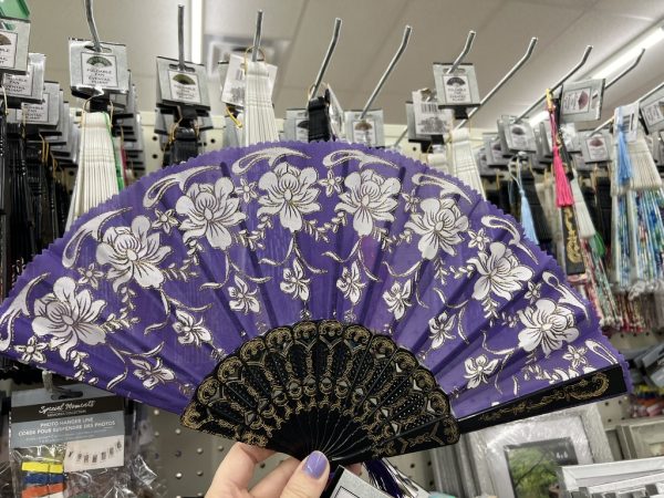 Open purple handheld fan