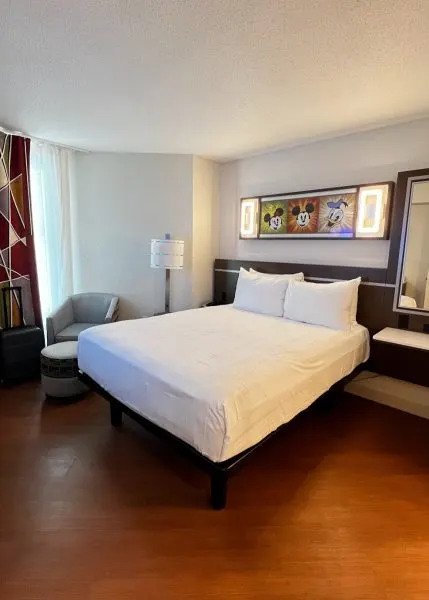 queen bed in bedroom of all-star music family suite
