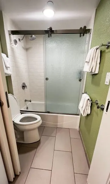 tub and shower combo in bathroom in all-star music family suites